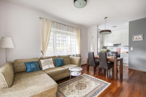 a living room with a couch and a table at M&R Apartament Airport&Business Premium Marina Mokotów - parking - WiFi - Netflix - self check-in, terrace - guarded estate - WAW Chopin Airport in Warsaw