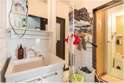 a small bathroom with a sink and a shower at Little Okawood - Vacation STAY 83117v in Ōkawa