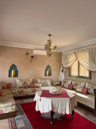 a living room with a couch and a table at Riad Timskrine in Marrakech