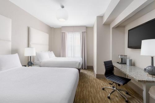 a hotel room with two beds and a desk at Holiday Inn Express Chicago - Magnificent Mile by IHG in Chicago