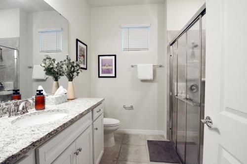 a bathroom with a toilet and a sink and a shower at Star Wars Moana Princess Mario Avatar Near Disney in Davenport