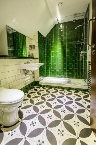 a bathroom with a toilet and a sink and a shower at Orange Tree in Richmond upon Thames