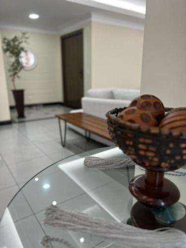 een woonkamer met een glazen tafel met een mand donuts bij APARTAMENTO EM EDIFICIO 100% MOBILIADO PARA TEMPORADA in Manaus