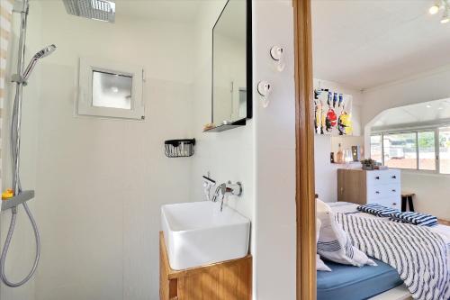 baño pequeño con lavabo y cama en NOUVEAU Cabanon Calanque de Niolon vue mer et port en Le Rove