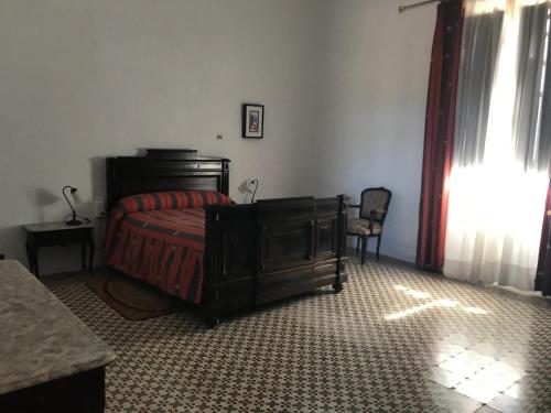 a bedroom with a bed and a table and a chair at La Almedina: Palacio de Foronda in Cazorla