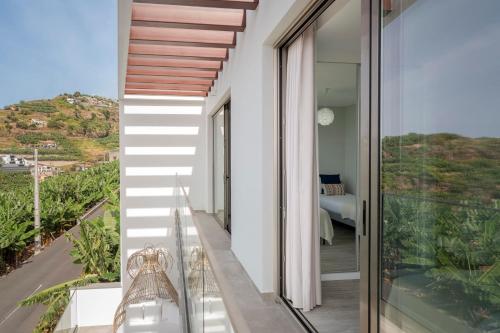 a balcony with a view of a bedroom at Vila Chu by An Island Apart in Ponta do Sol