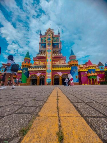 a large building in front of a disney castle at Pousada Ametista - Penha, SC - 1,5 km do Parque Beto Carrero World in Penha
