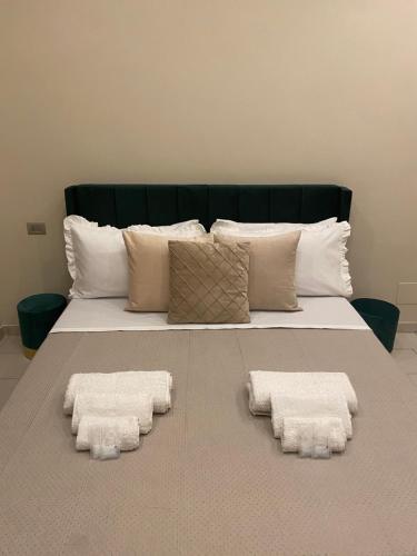 a bed with two white towels on it at La Dimora di Antonella in Naples