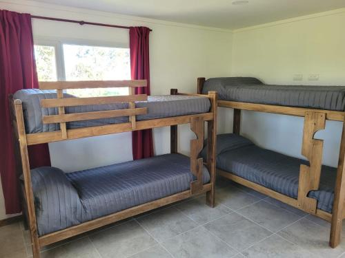 a room with three bunk beds and a window at Casa a estrenar en Santa Elena - Santa Clara, Costa Atlantica in Playa Dorada