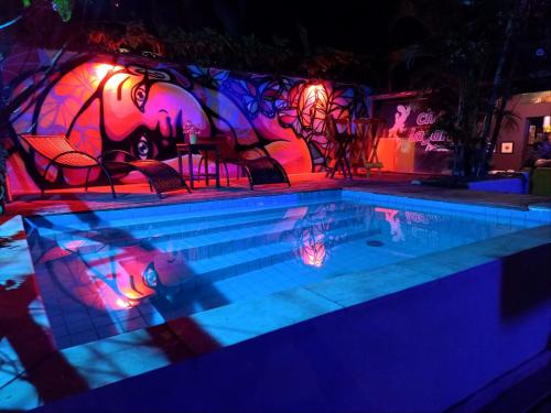 a swimming pool with purple and pink lights on it at Che Lagarto Paraty in Paraty