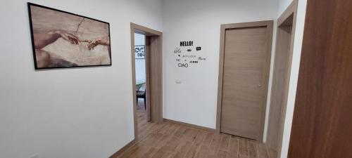 a hallway with a painting on the wall next to a door at La Porta Verde 8 in Collecchio