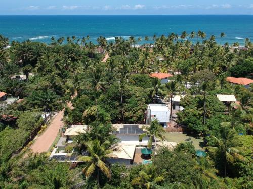 an aerial view of a resort with the ocean in the background at LAUS Bangalôs Experience - Piscina Privativa - Praia de Algodões - Península de Maraú - Bahia in Praia dos Algodões