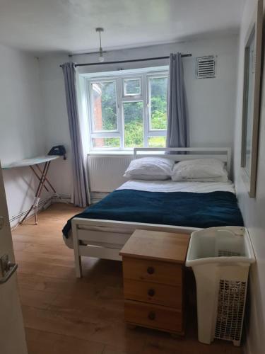 a small bedroom with a bed and a window at Vivian House in London