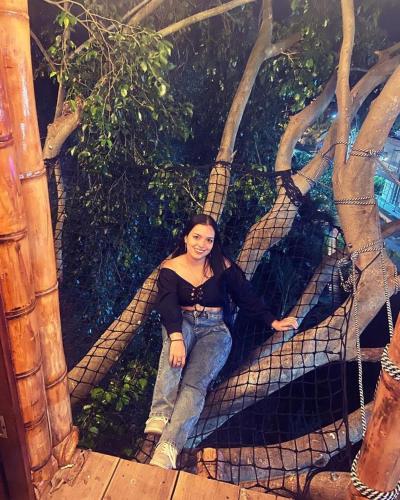 a woman laying on top of a net at Hotel Campestre La María Toro Valle in Toro