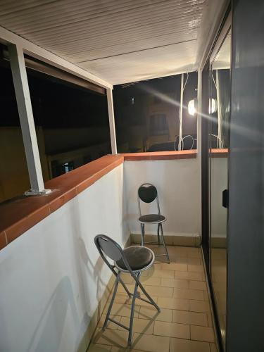 two chairs sitting on the balcony of a boat at VeraHouse in Palermo