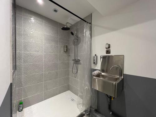 a bathroom with a shower and a sink at 50 nuances de gris - BDSM - Loveroom in Souppes-sur-Loing