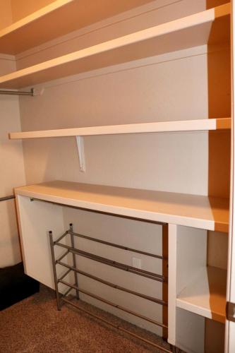 a closet with white shelves and a desk at Southwestern Comfort Stay 2B in Las Cruces