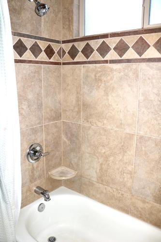 a bathroom with a shower with a tub and a sink at Southwestern Comfort Stay 2B in Las Cruces