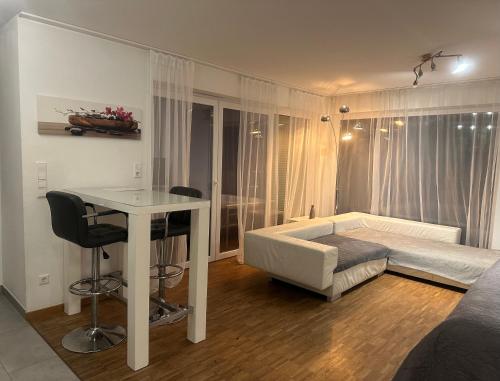 a bedroom with a bed and a desk and a table at Ferienwohungen Akwant in Baden-Baden