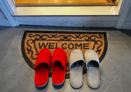 two pairs of red shoes on a door mat at Stunning SanFran Casa close to Center and steps from Ocean in San Francisco
