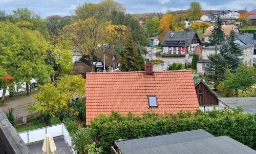 un toit orange sur une maison dans une ville dans l'établissement SKOLIMÓWKA, à Chmielno