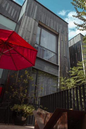 a red umbrella in front of a building at Elena de Cobre, Leon, a Member of Design Hotels in León