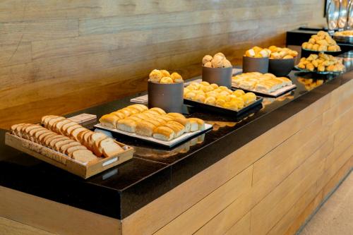 a buffet with many different types of bread and pastries at Lagune Barra Hotel in Rio de Janeiro