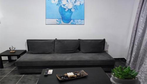 a living room with a couch and a table at Dreams 1 in Kardítsa