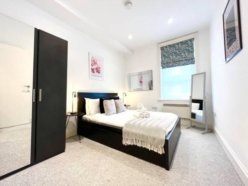 Un dormitorio con una cama grande y una ventana en 2 Bedroom Apartment-Oxford Street-Central London, en Londres