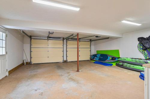 a garage with two garage doors and kayaks in it at Living Among The Oaks in Stevensville