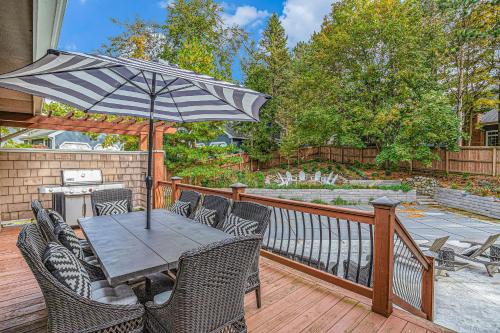 a table and chairs with an umbrella on a deck at Living Among The Oaks in Stevensville