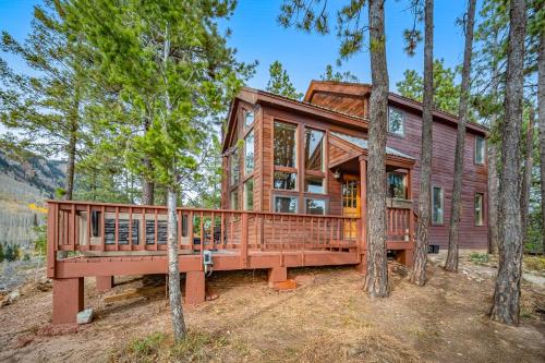 a home in the woods with a large deck at Top of the Mesa in Durango