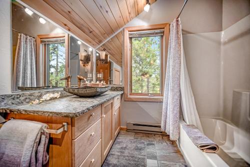 a bathroom with a sink and a tub and a mirror at Top of the Mesa in Durango