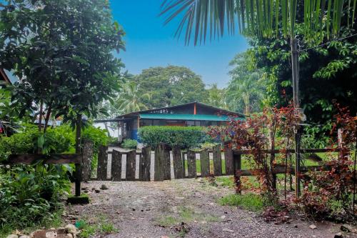 a house in the middle of a forest with a fence at Casa Beluga in Uvita