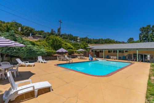 a pool with chairs and tables and a building at Quality Inn & Suites in Jackson