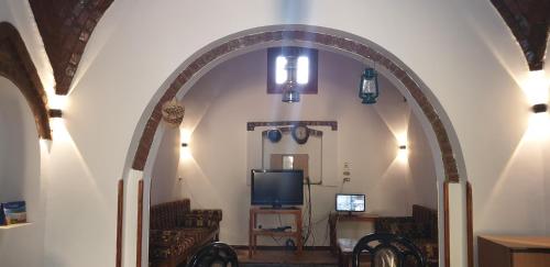 an archway in a room with a tv and chairs at Luxor Villa Hatshepsut in Luxor