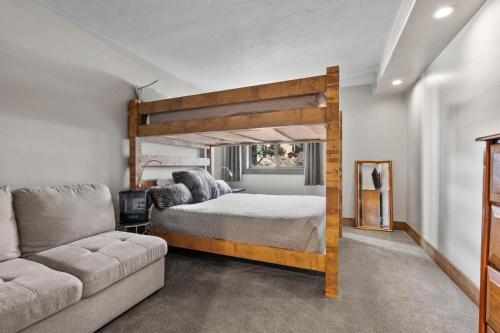 a bedroom with a bunk bed and a couch at Corinthian Circle - Dillon in Dillon