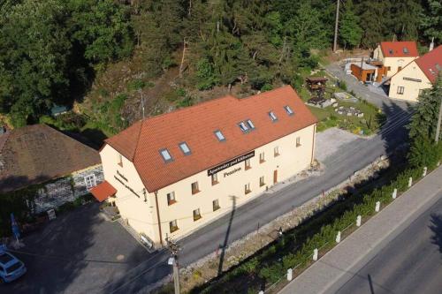 an overhead view of a large building with a red roof at Apartmány pod Klášterem in Kladruby