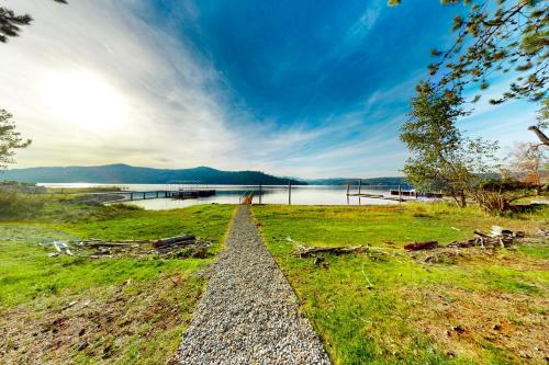 a road leading into a field with a lake at Cabin On The Lake in Harrison