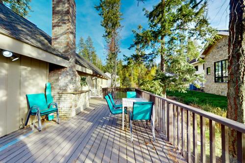 a deck with chairs and a table on a house at Cabin On The Lake in Harrison