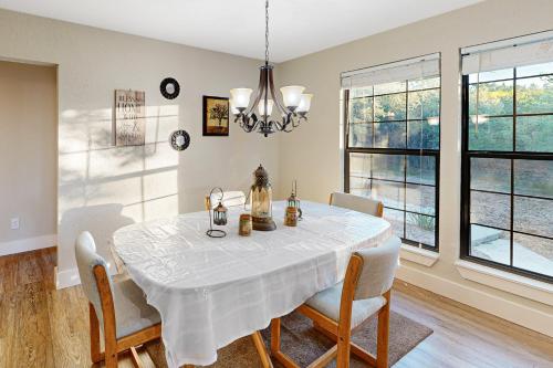 a dining room with a white table and chairs at The Los Madrone Home in Pipe Creek