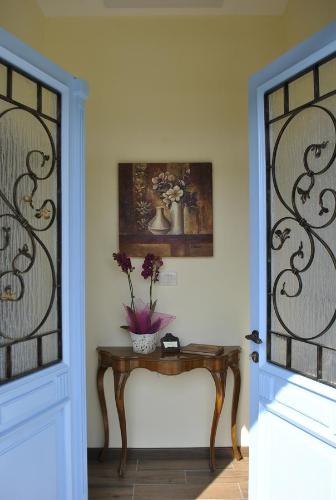 a room with a table with a vase of flowers on it at Apartment Pod Kostanji in Osp