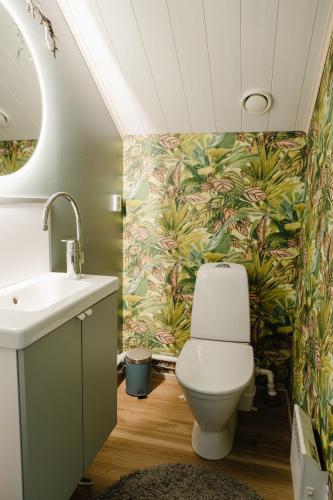 a bathroom with a toilet and a sink at Arcticmint in Rovaniemi
