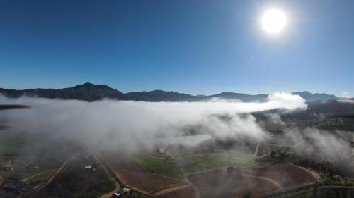 a view of a foggy valley with the sun in the sky at Residencia Artistica CasaVino in Casablanca