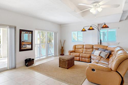 a living room with a couch and a ceiling fan at Fantastic Fifth Street in Key Colony Beach