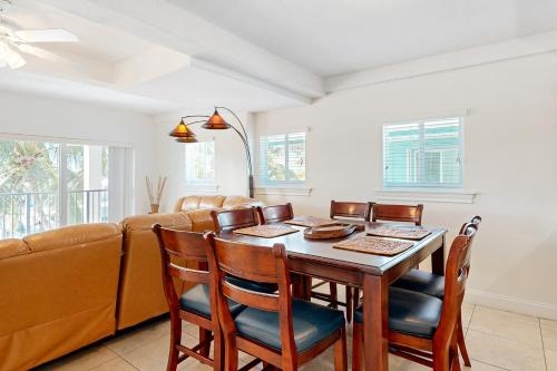 a dining room with a table and chairs and a couch at Fantastic Fifth Street in Key Colony Beach