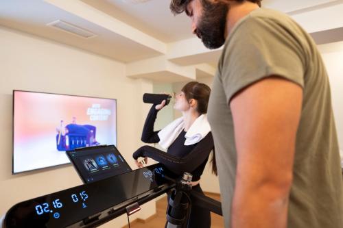 a man and a woman singing in a recording studio at Wellness Smart Suites in Bolzano
