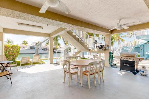 a patio with a table and chairs and a piano at Fantastic Fifth Street in Key Colony Beach