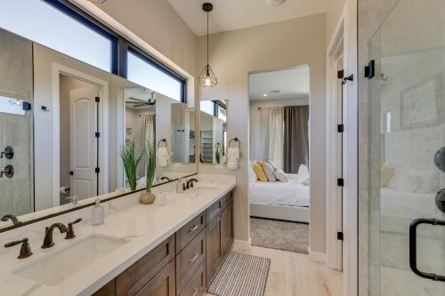 a bathroom with two sinks and a shower and a bed at Luxurious Desert Oasis Fireplace and Private Pool! in Apache Junction