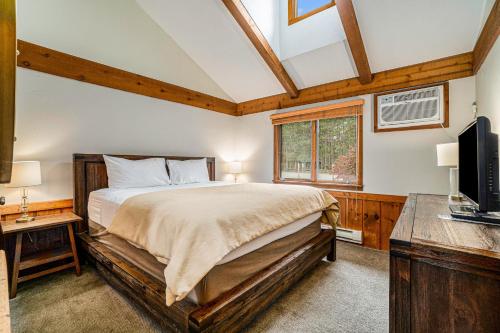 a bedroom with a bed and a desk and a television at Pinehurst Paradise A in Thompsonville